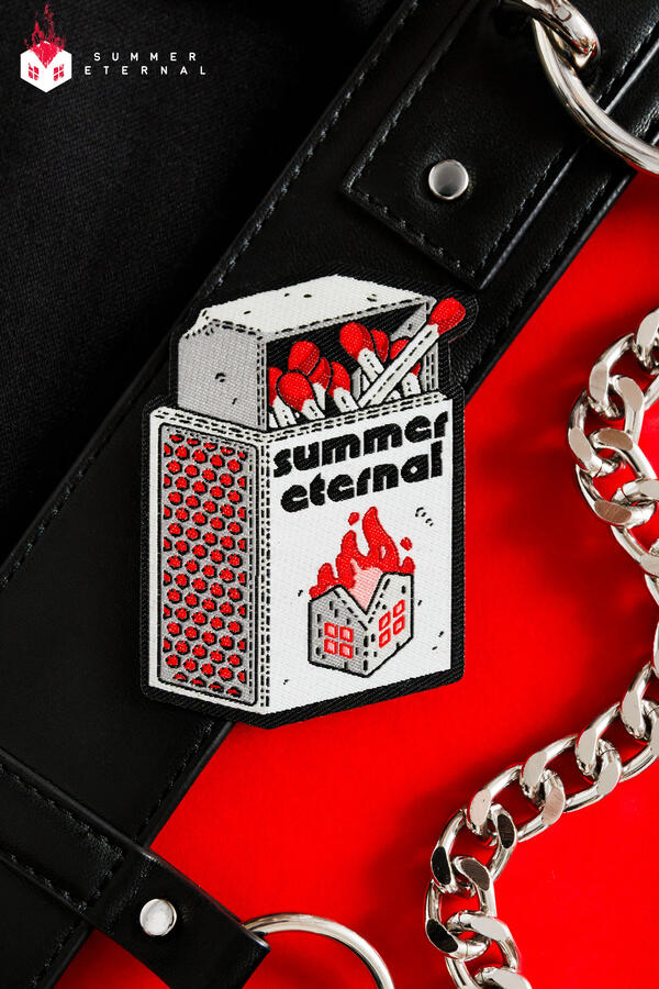 Photo of a black, white and red half-opened matchbox with a burning house drawn on the outer part of the box. Photo of a black, white and red half-opened matchbox with a burning house drawn on the outer part of the box.